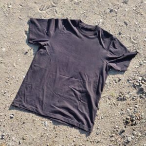 Plain black shirt on dirt surface